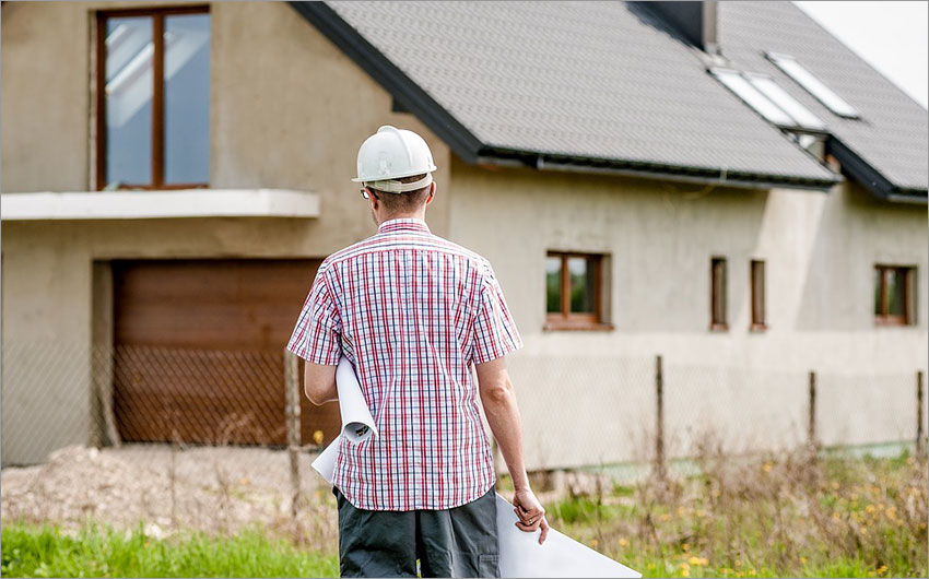 Builder walking toward a home